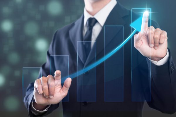 Man in suit with fingers making an ascending line