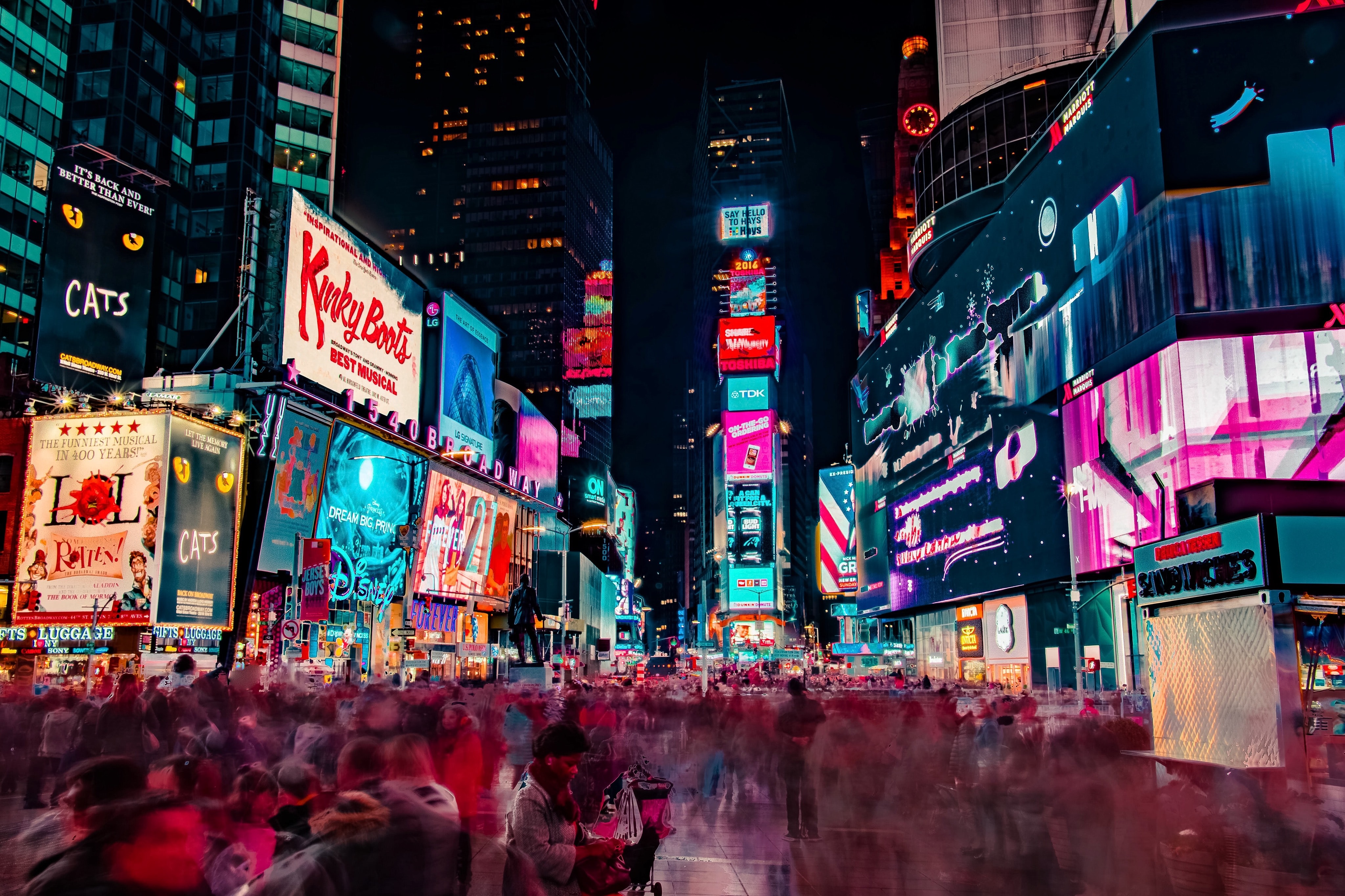 Times square with lots of people and bright lights
