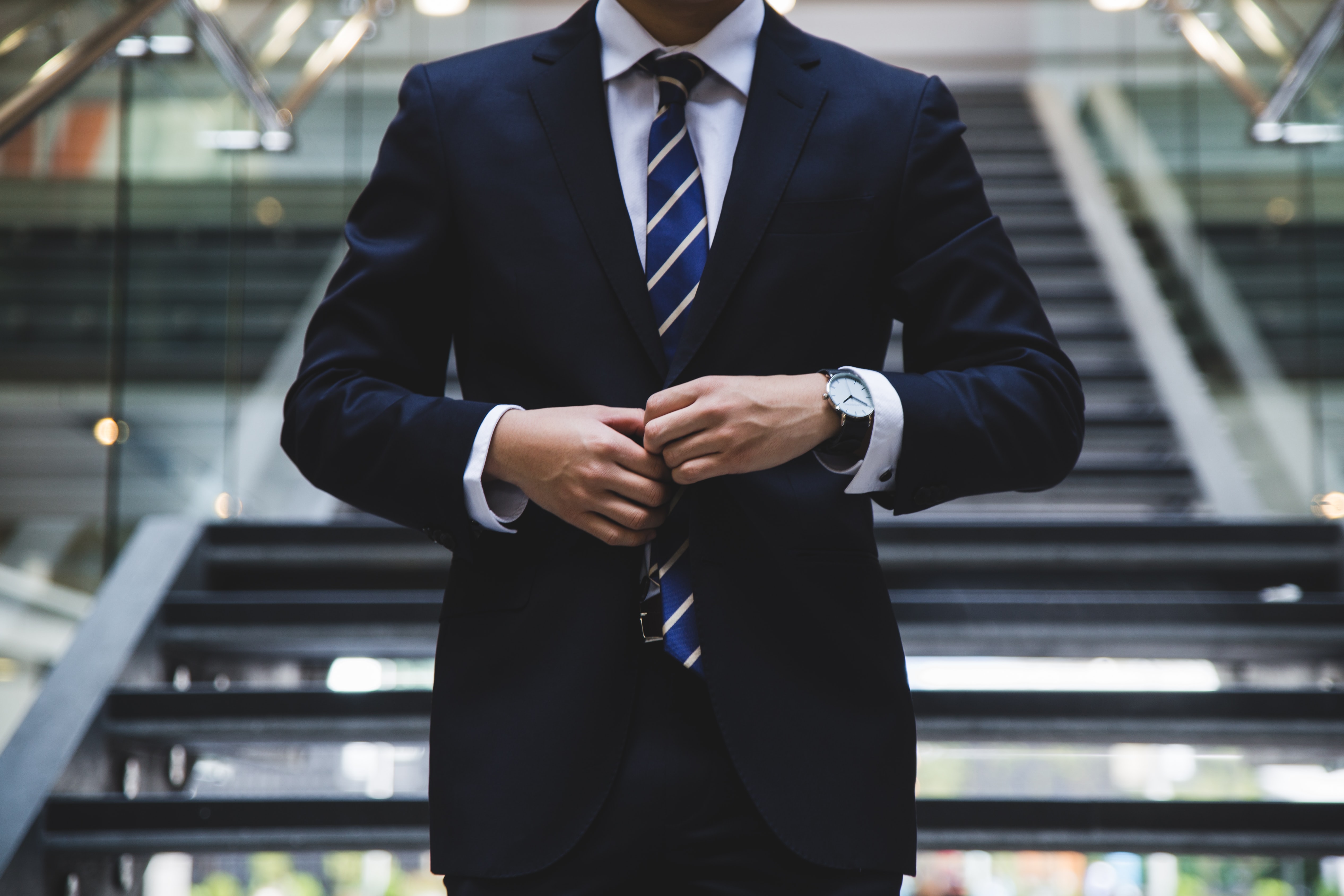 Man walking down the stairs wearing a suit