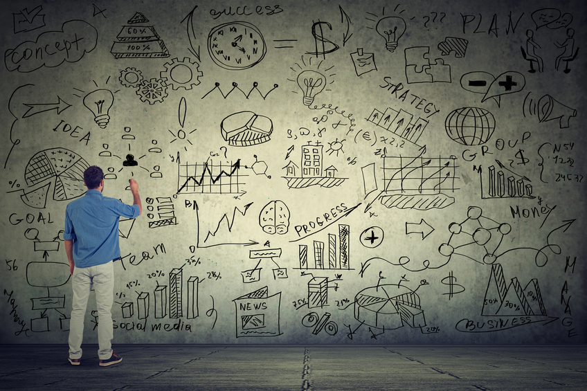 Man drawing and writing things on the wall