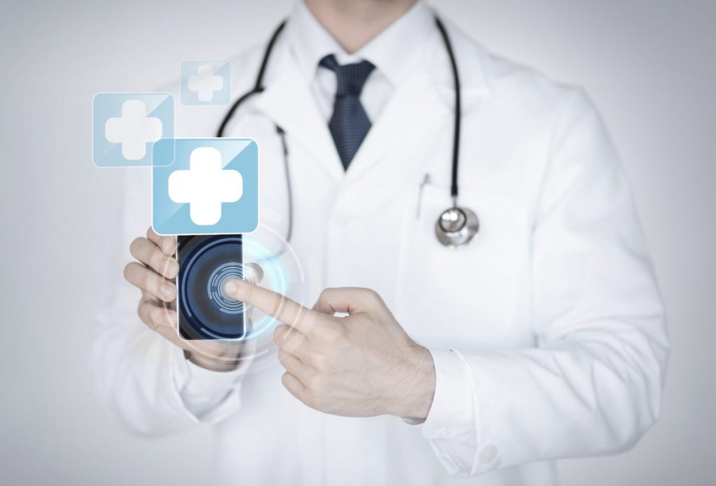 A person in medical robe holding a phone