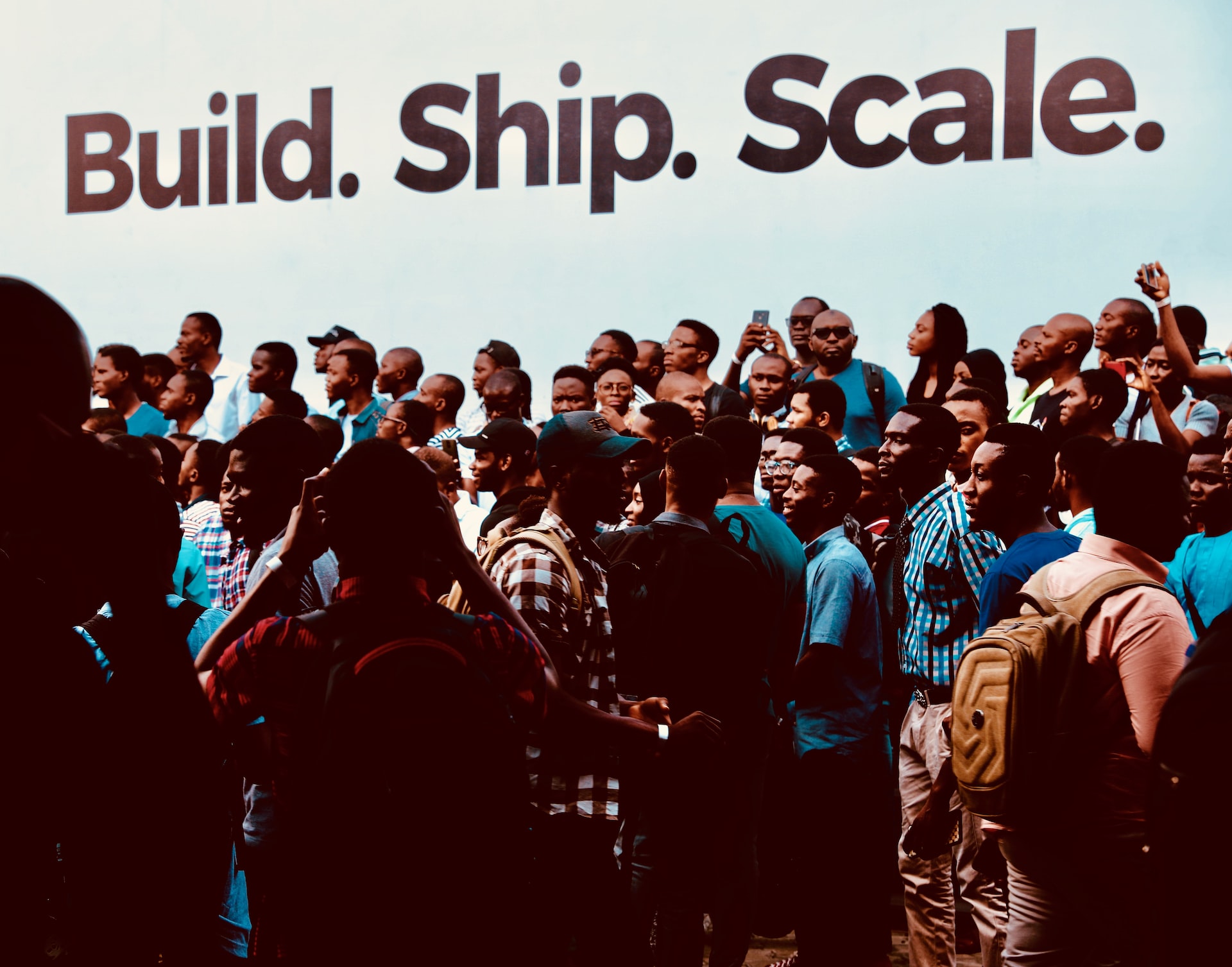 A crowd near the screen hat says Build Ship Scale