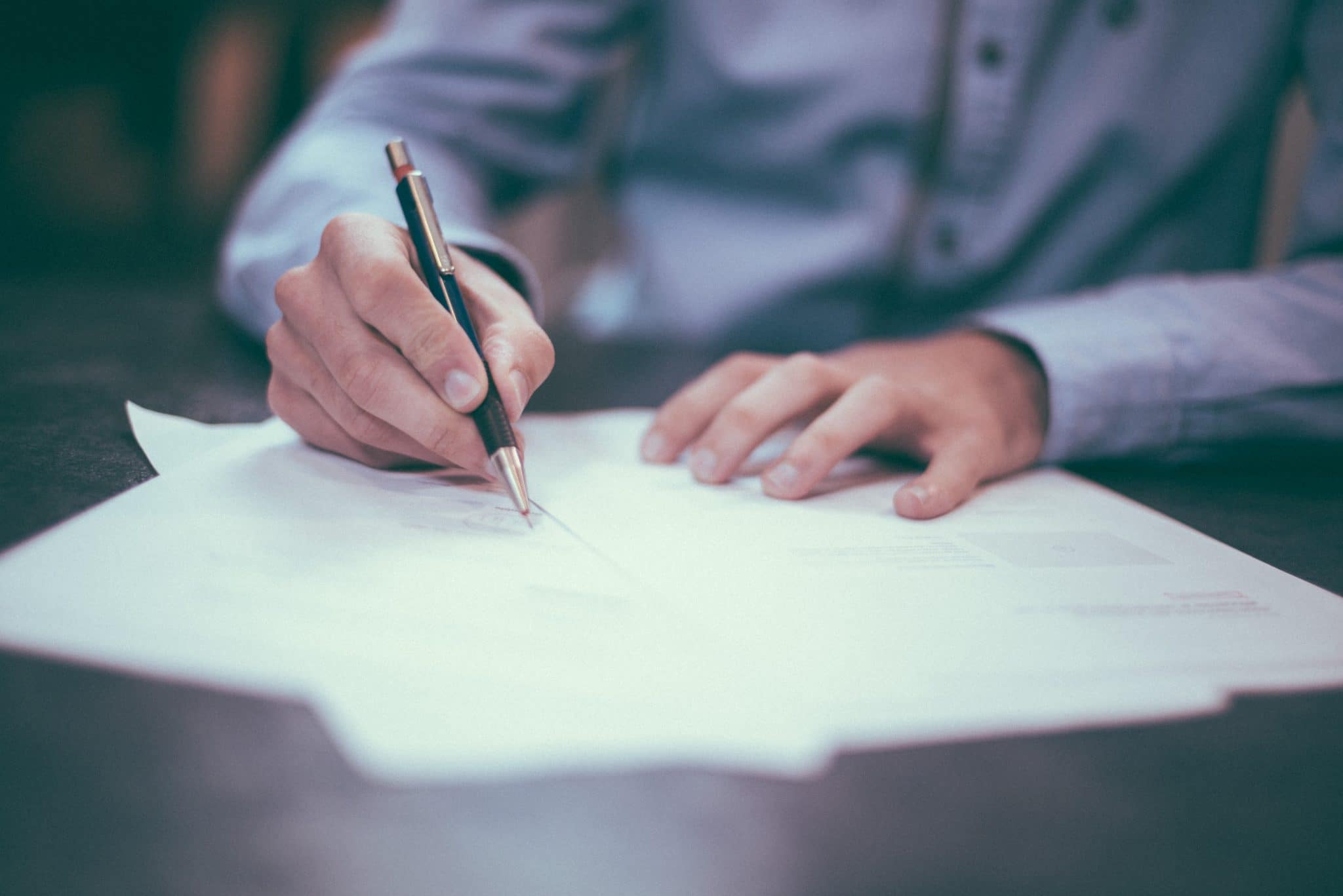 A man writing in a paper