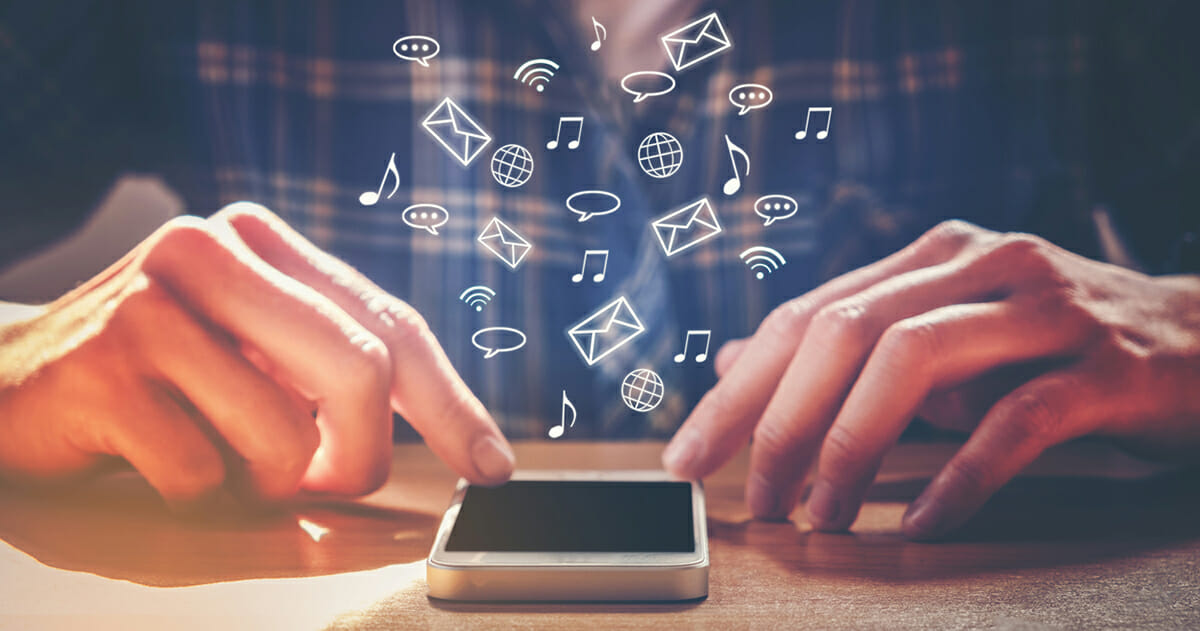A man frequently receives notifications while performing other tasks on his smartphone