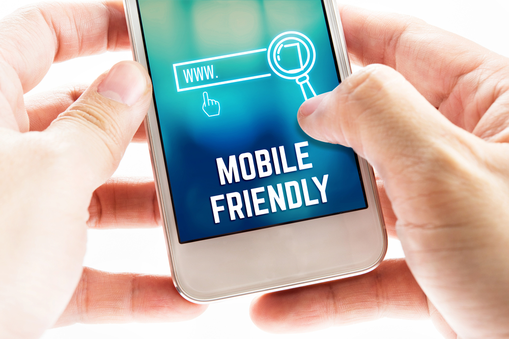 A person's hand optimizing the search box on a mobile device