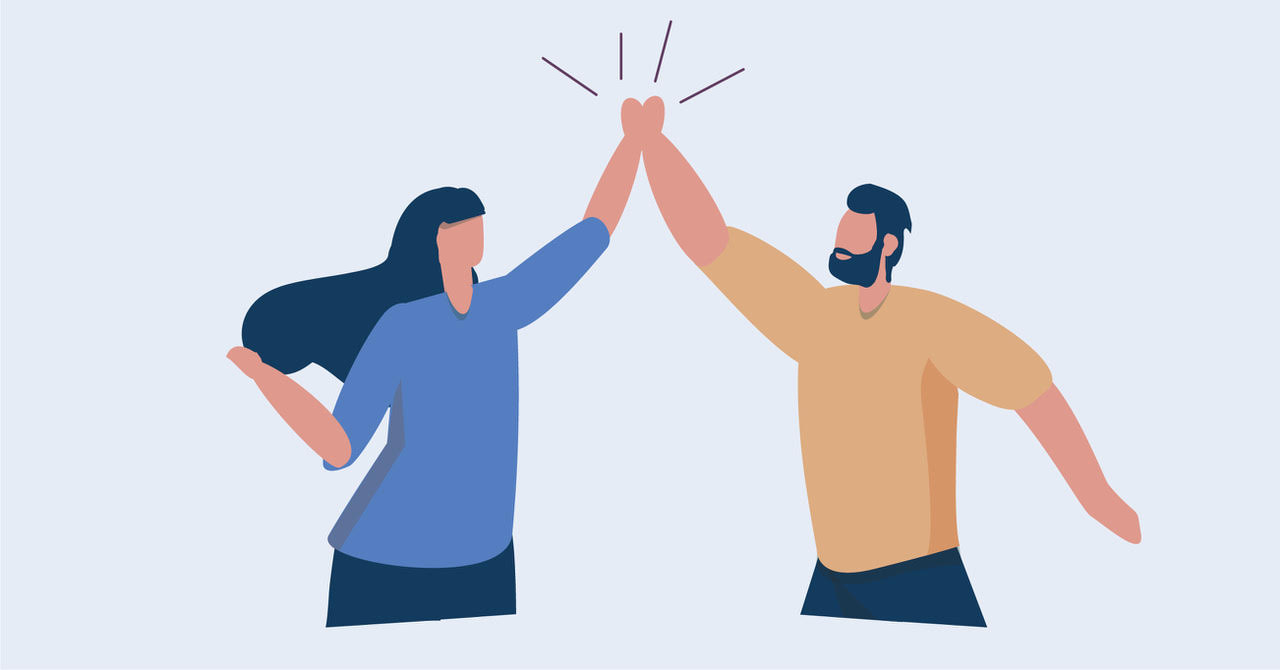 A male and female content creator exchange high fives