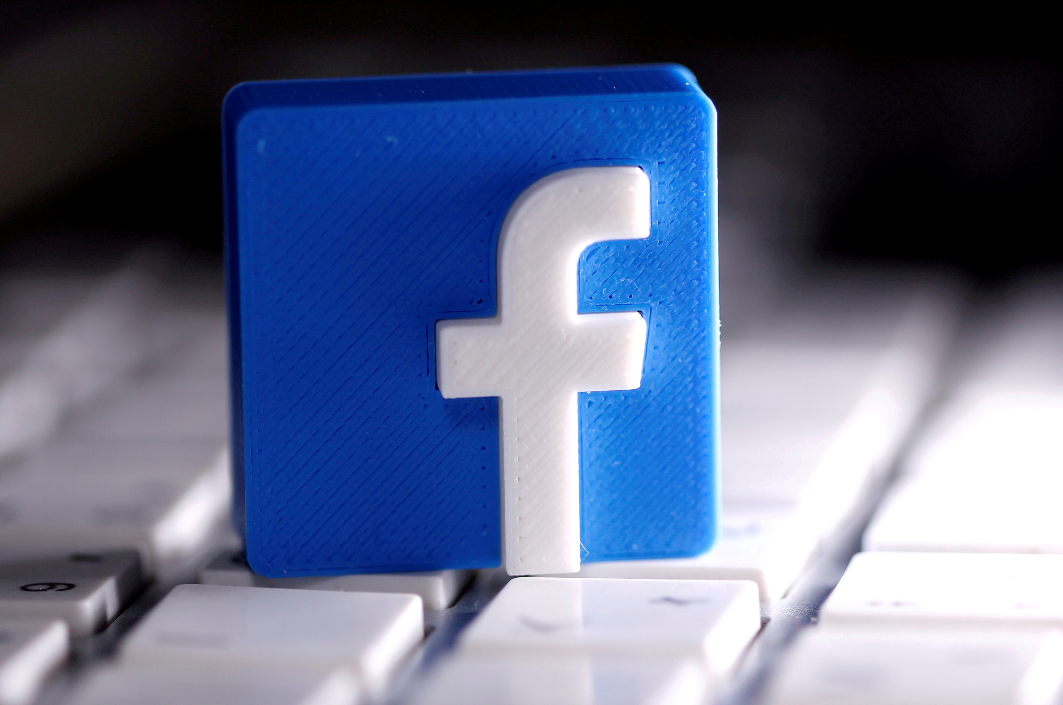 Facebook logo on a white keyboard