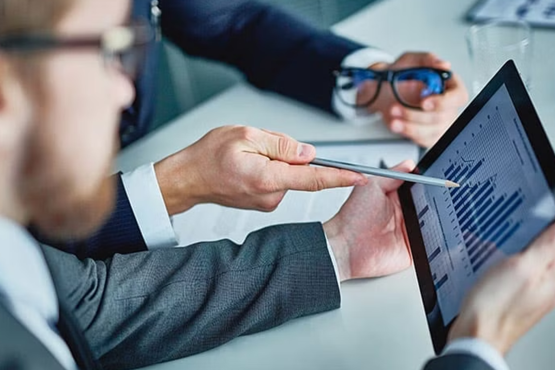 A SEO with an iPod and a graph chart stands next to a man with an eyeglass