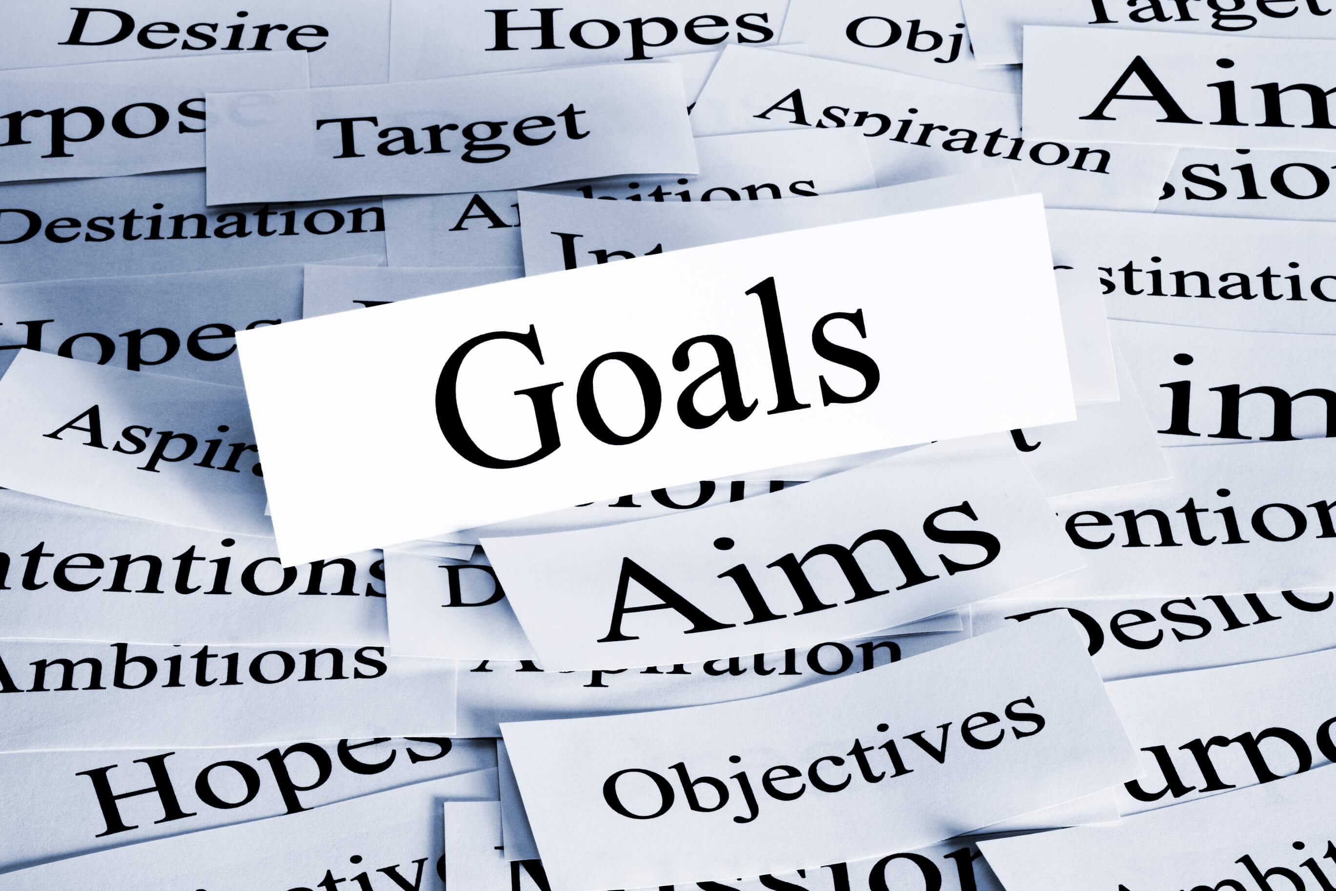 Pieces of paper, with one highlighting the word "Goals"
