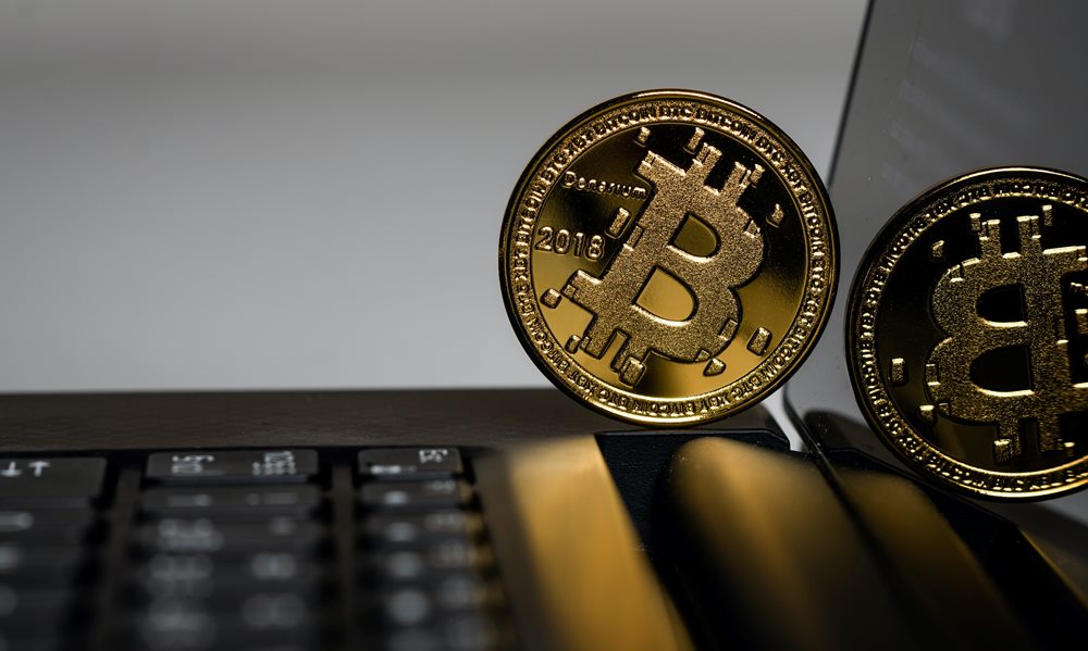 Gold Bitcoin on a laptop