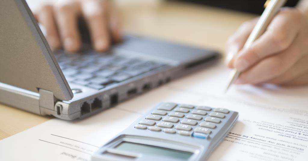 Laptop and calculator with papers