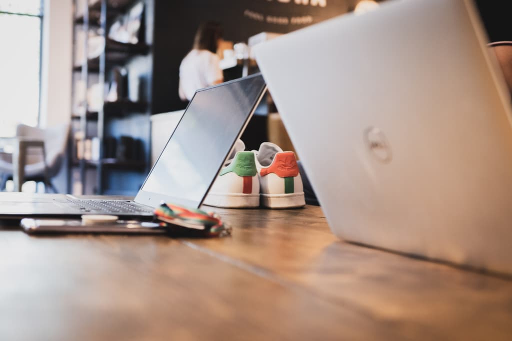 Two laptops on a wooden table