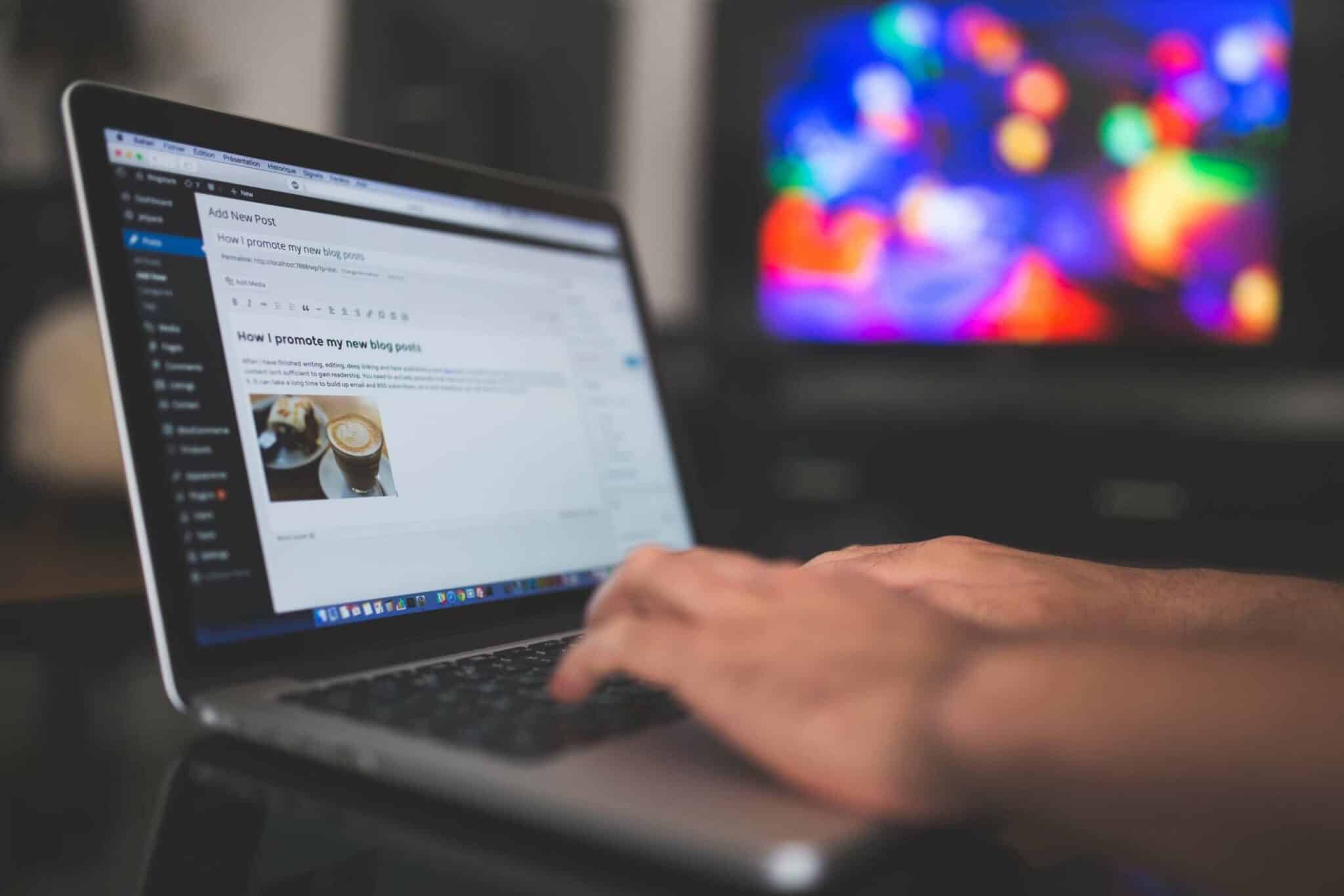Hands typing on a laptop