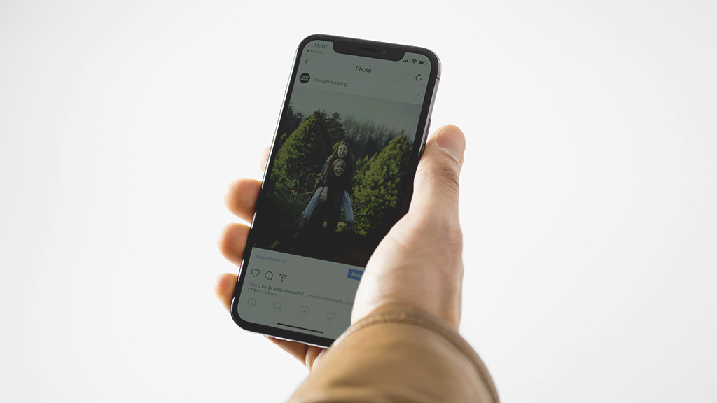 Hand holding an iphone with dark screen