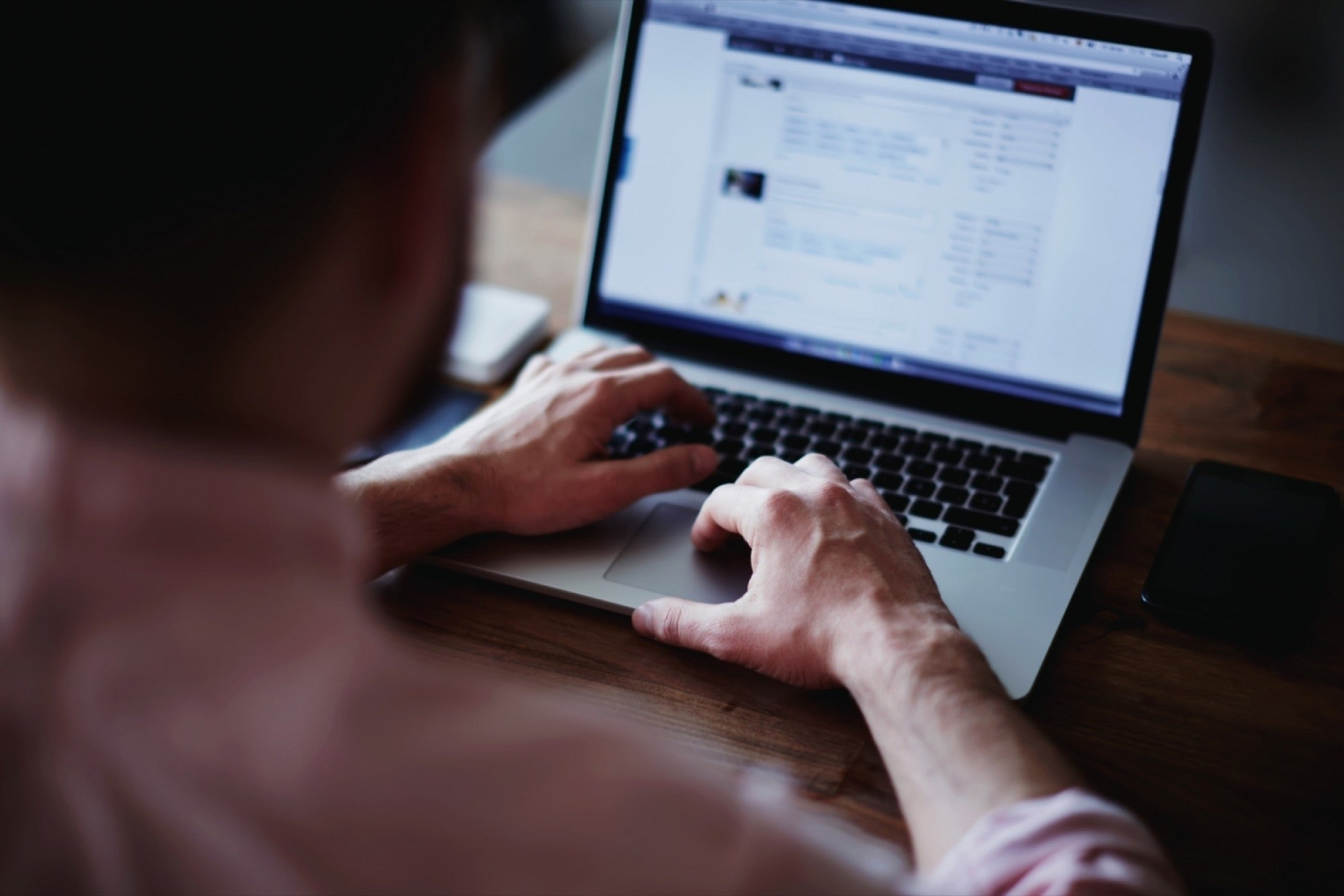 A man typing on a laptop