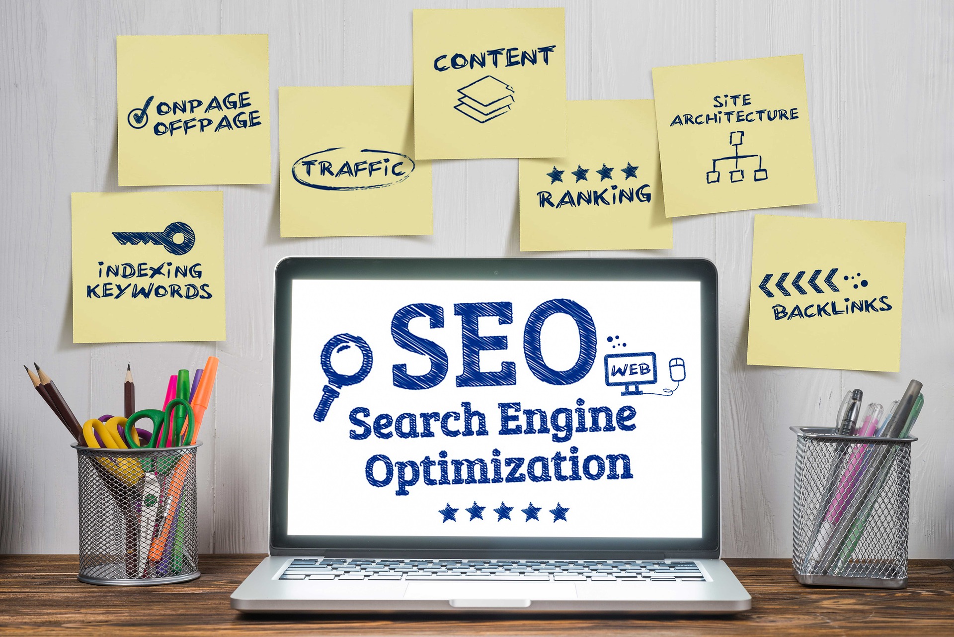 SEO search engine optimization written on a latpop screen with sticky papers on the wall