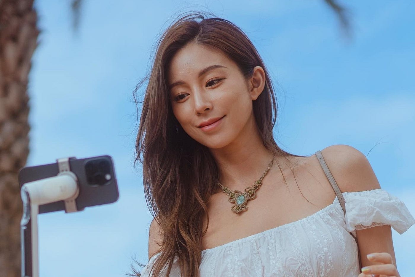 A woman smiling in front of a phone