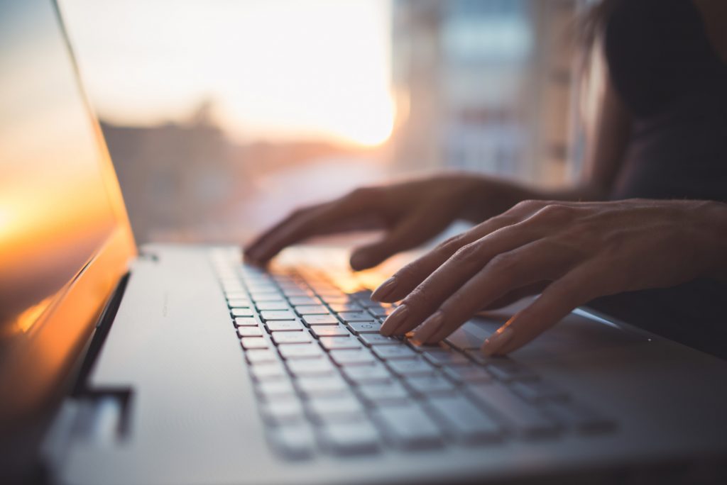 A person typing on a laptop